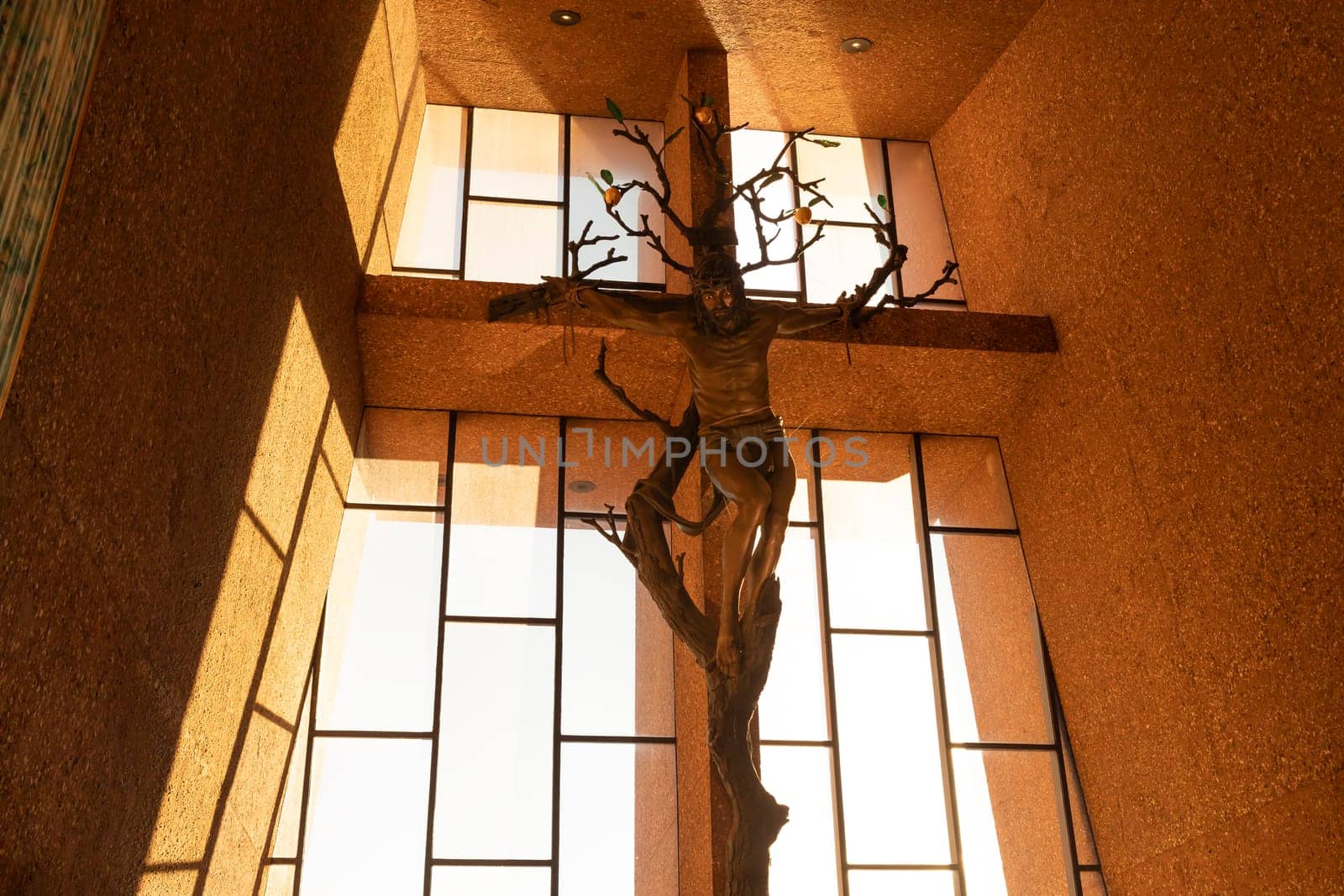 Interior of Chapel of the Holy Cross, Bronze Crucifix, Jesus In Roman Catholic Church Built Into Red Rock Buttes Of Sedona, Arizona. Spiritual Place. Horizontal. Sedona, USA, NOV 26, 2023 by netatsi