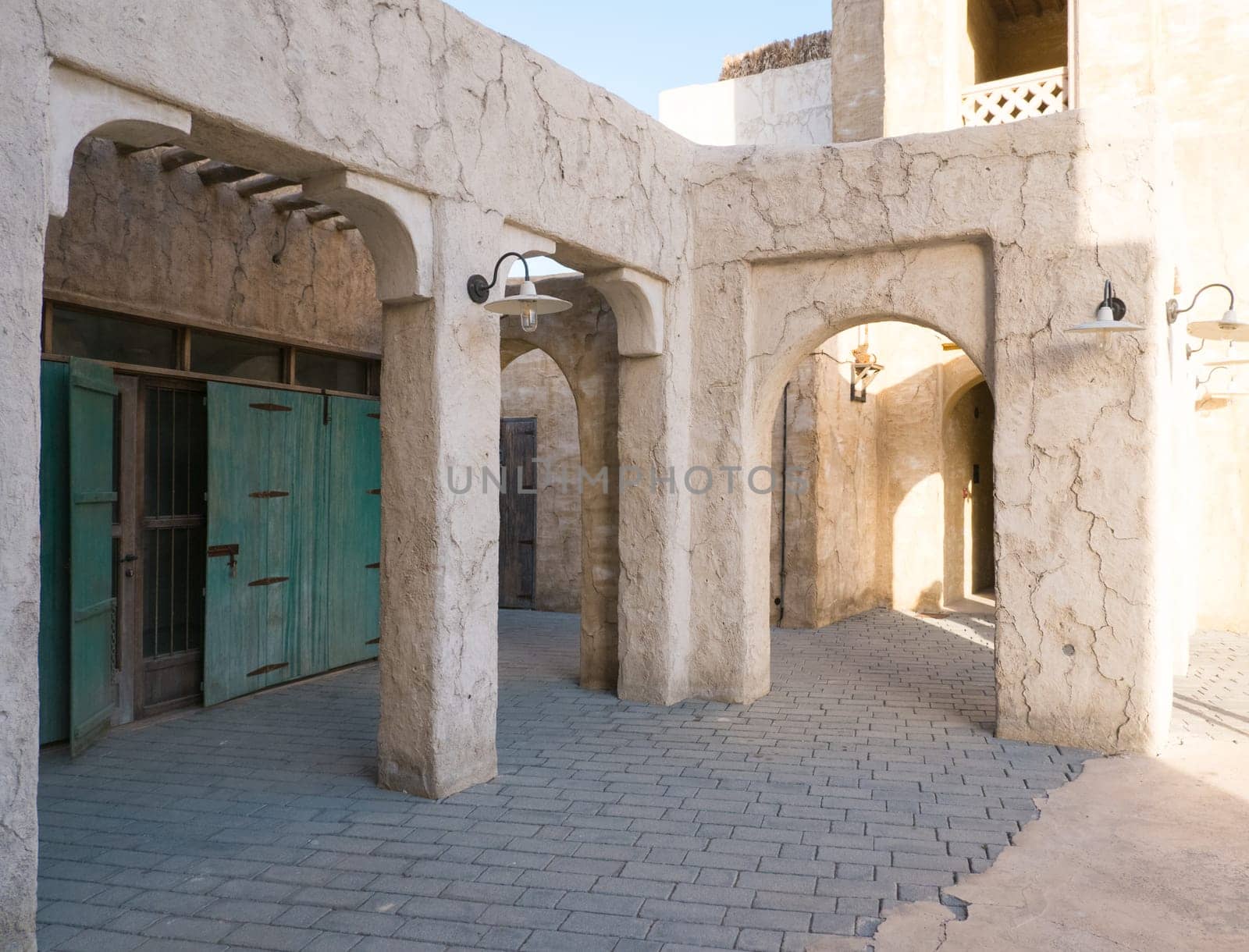 Narrow streets that create shade on a hot day in the old city of Dubai Creek and Bur district. Travel destinations and heritage village by Ekaterina34