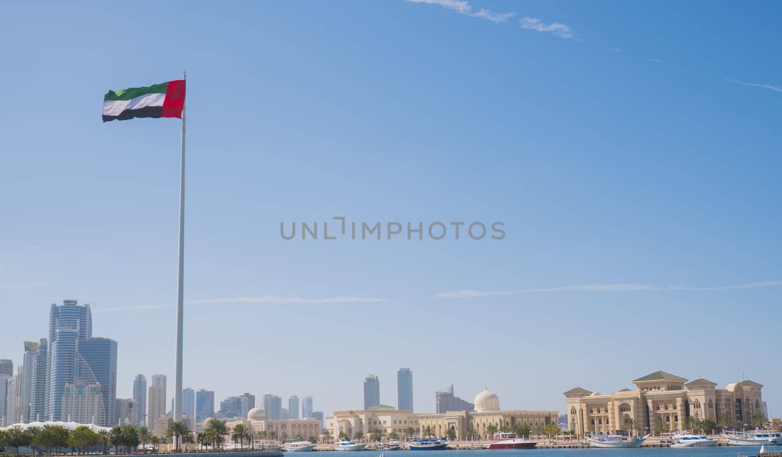 SHARJAH, UAE - February 14, 2023: Flag of the United Arab Emirates in Sharjah on the coastline