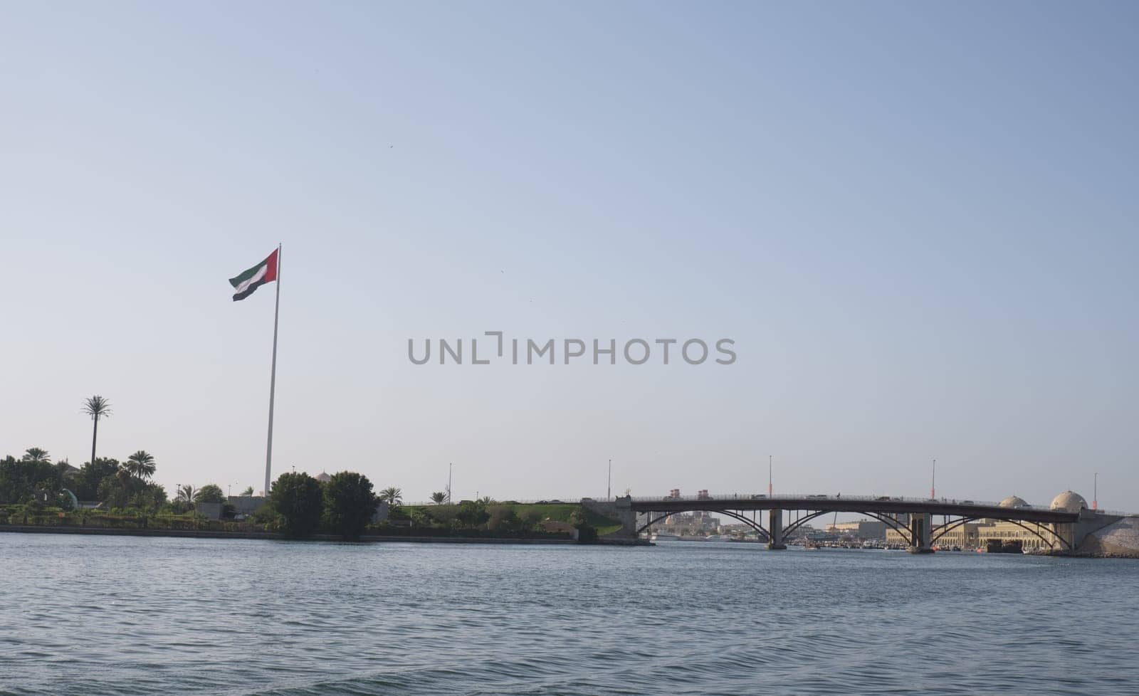 Sharjah cityscape with UAE flag
