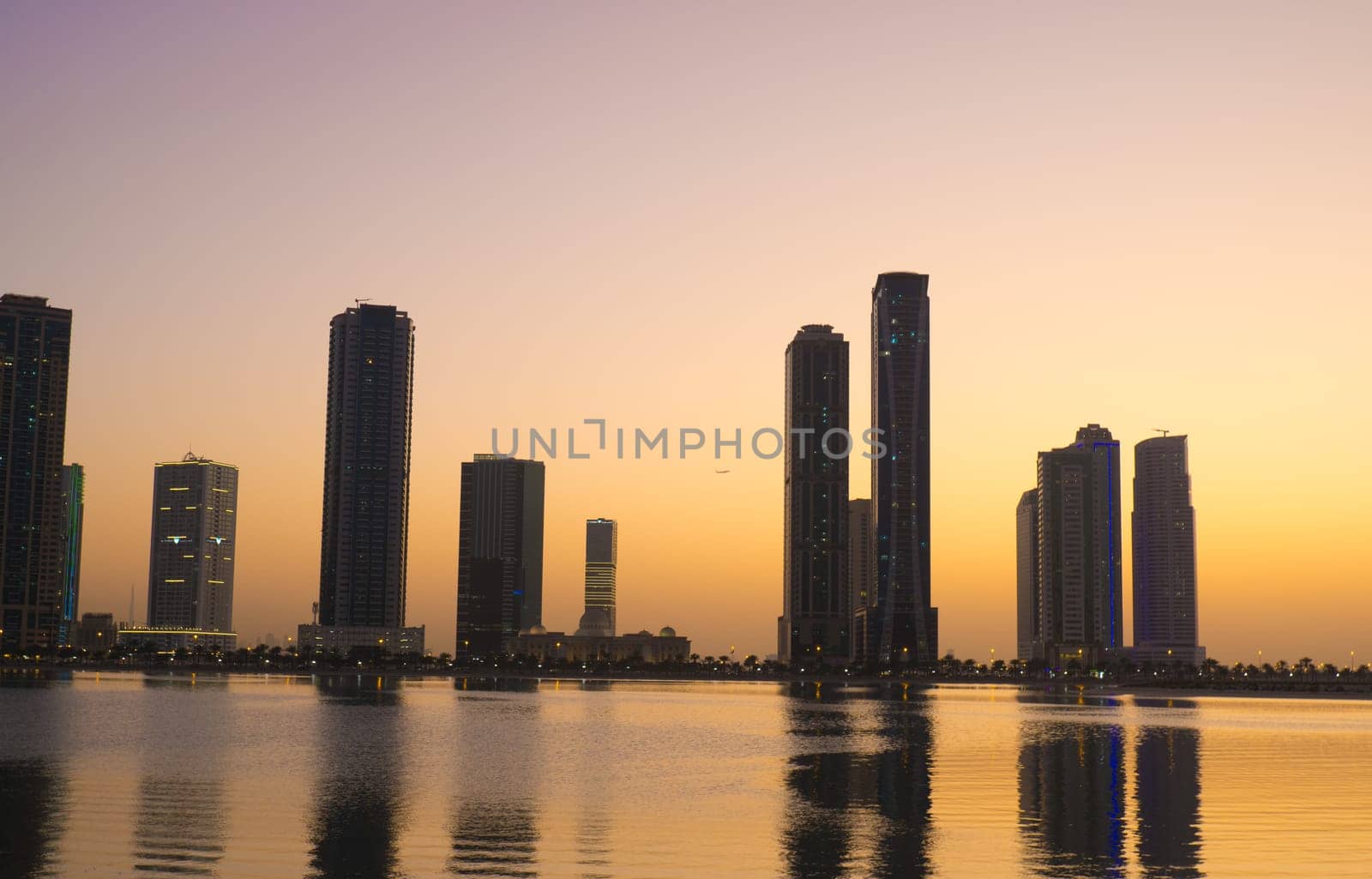 Night landscape of the embankment of the emirate of Sharjah, United Arab Emirates.