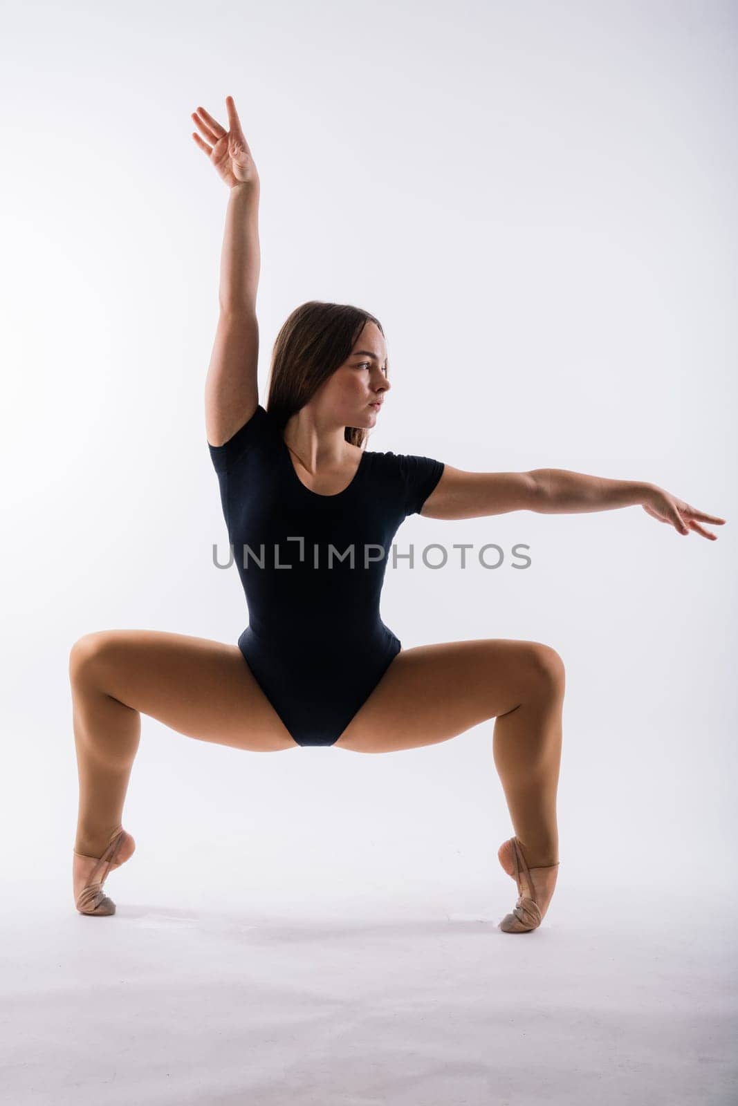 Gymnastics, woman acrobat, female gymnast strong flexible body over black and white backgrounds