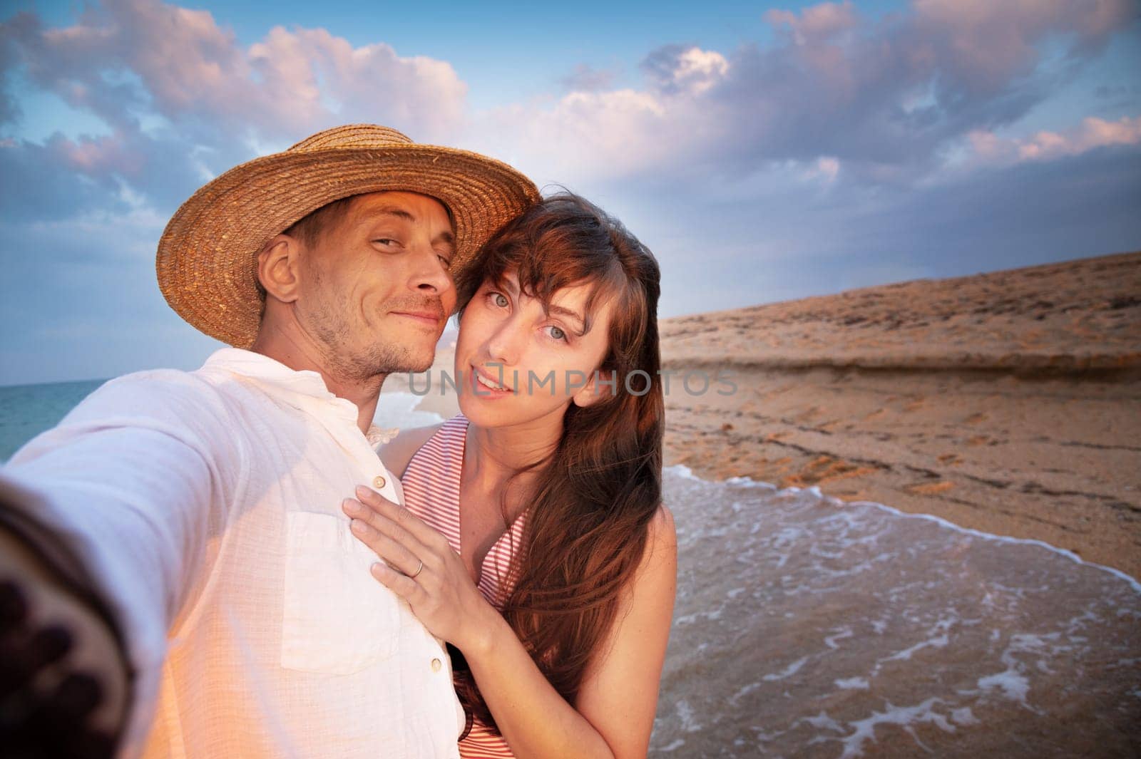 Close up smiling happy young couple two family man woman in casual clothes hug each other doing selfie shot pov on mobile phone. at sunrise over sea beach outdoor seaside in summer day sunset evening.