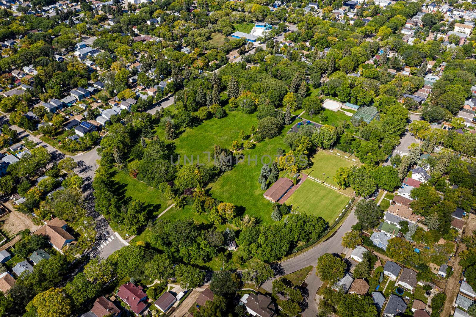 Discover the beauty of Ashworth Holmes Park in Saskatoon. This image showcases its sprawling lawns, vibrant playground, and inviting picnic spots, a beloved urban green space for all ages.