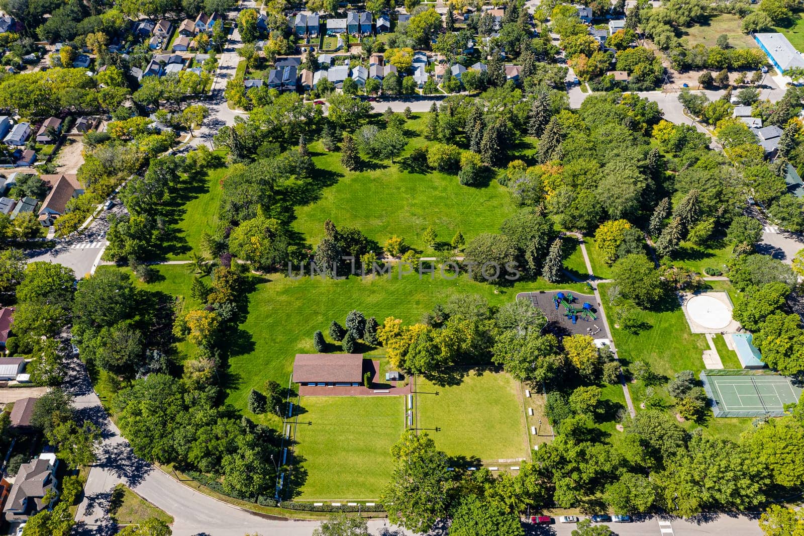 Discover the beauty of Ashworth Holmes Park in Saskatoon. This image showcases its sprawling lawns, vibrant playground, and inviting picnic spots, a beloved urban green space for all ages.