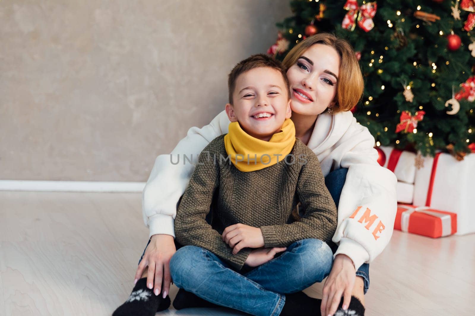 Mom with son at the Christmas tree