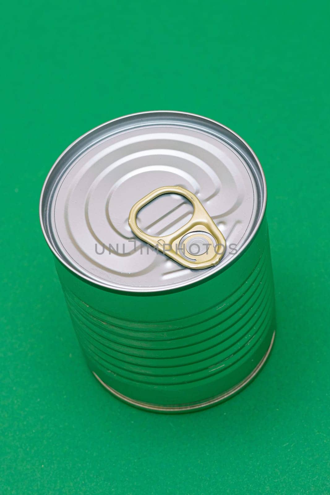 Unopened Tin Can with Blank Edge on Green Background by InfinitumProdux