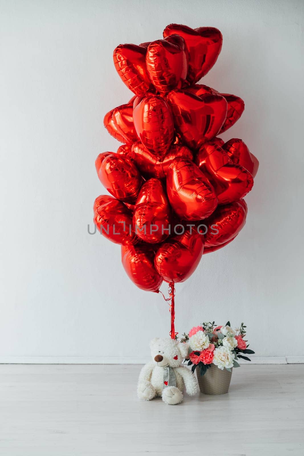 a Air Red Balloons with Soft Toy and Flowers Gift in Bright Room