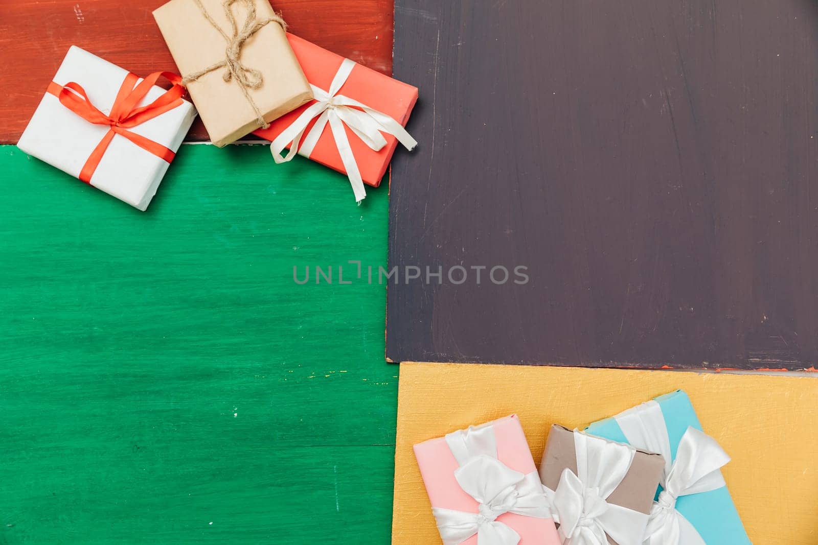 many gifts lie on a red green and yellow background by Simakov
