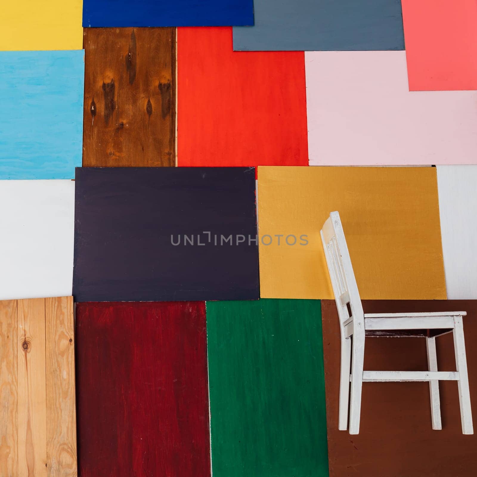 a squares of different color red blue black brown white green with white chair as background