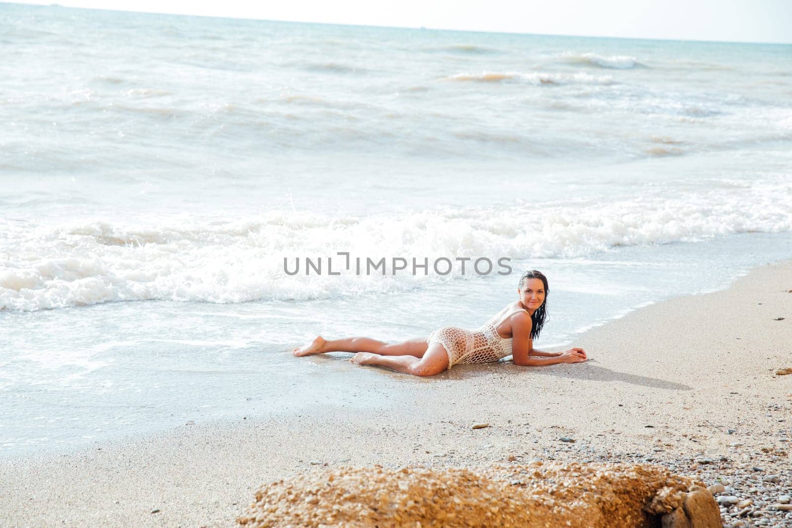 woman in light clothes lies on the beach holiday on the beach