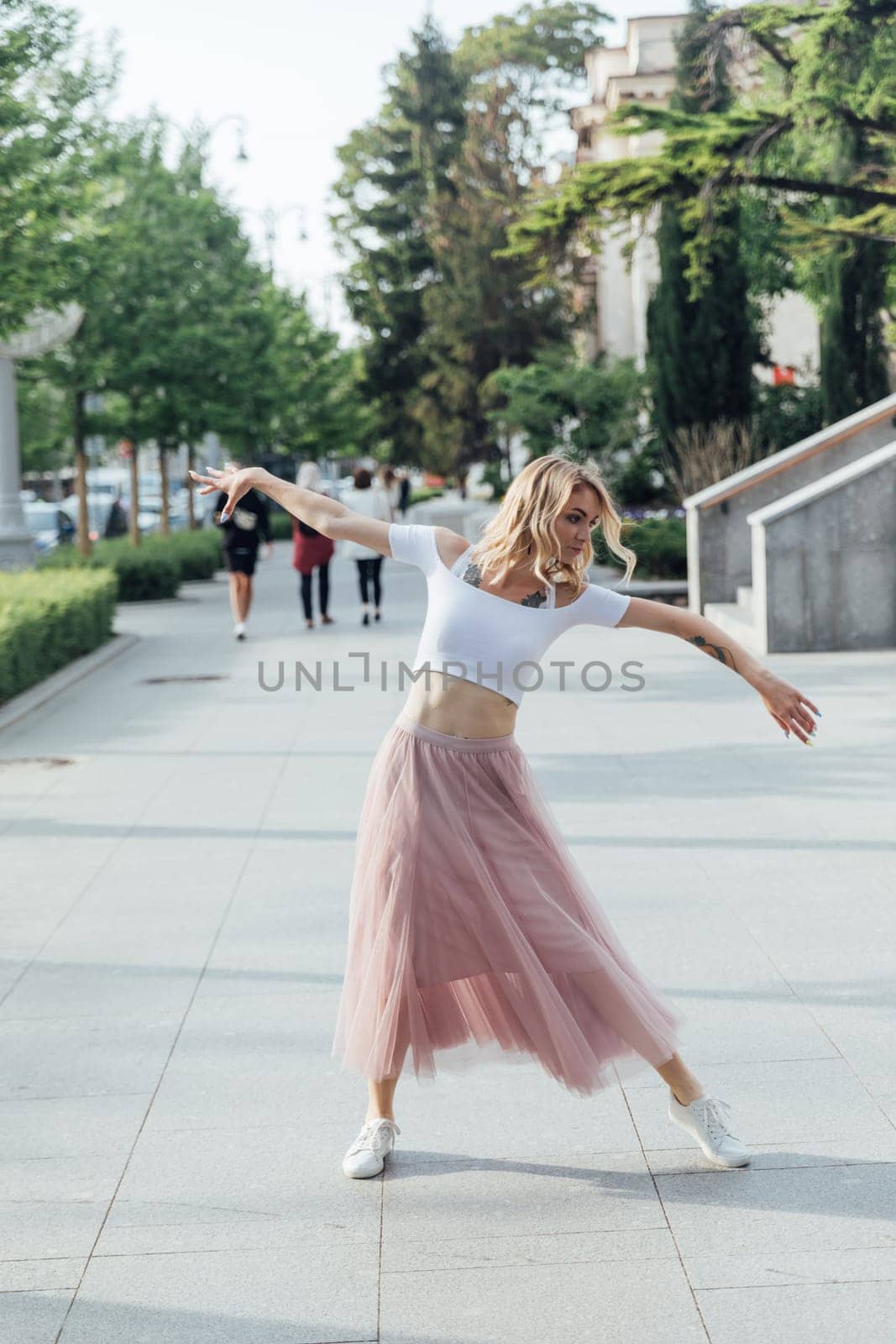 woman in a pink skirt dancing in the street