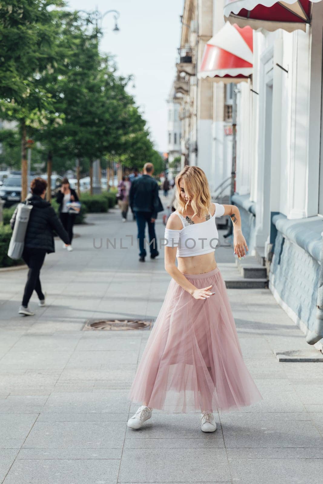 woman in a pink skirt dancing in the street