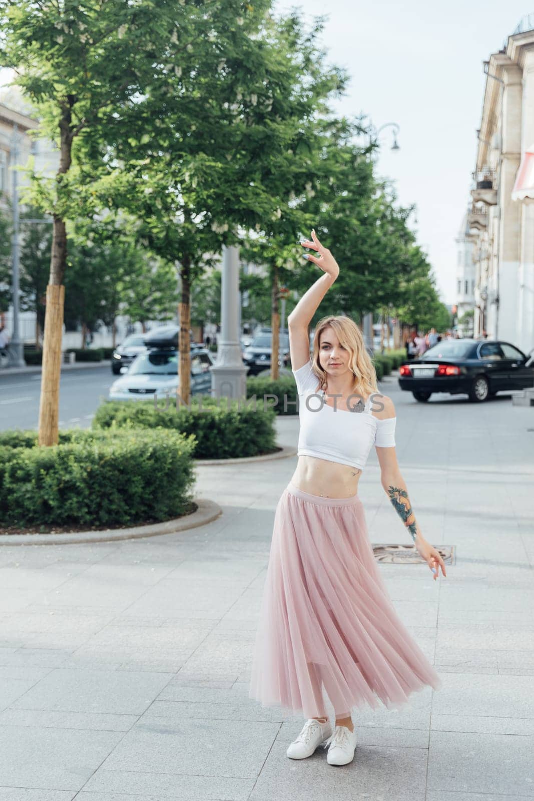 woman in a pink skirt dancing in the street