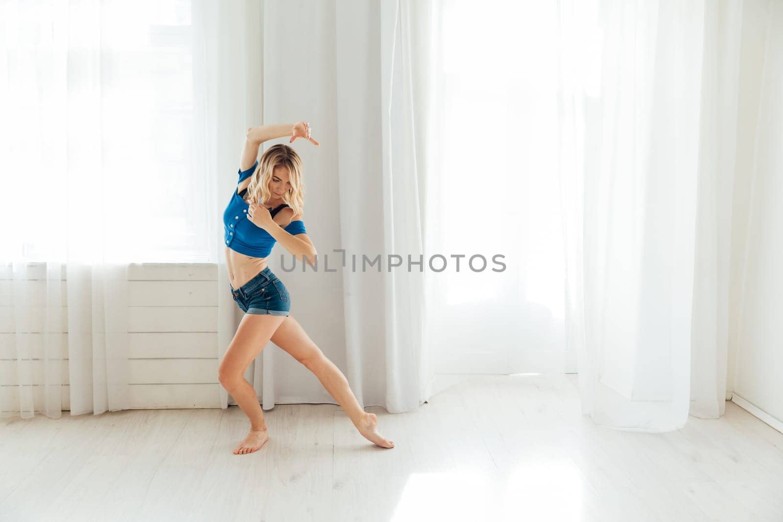 female dancer moves dance elements in the studio in the contemporary dance hall