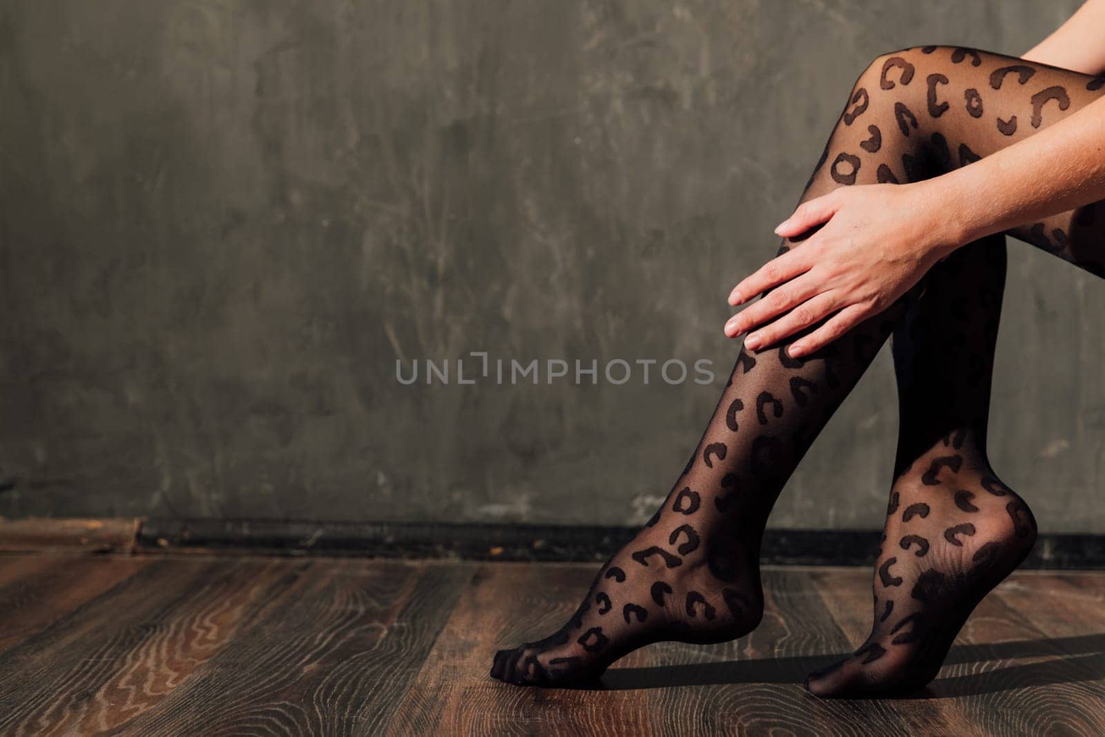 a women's slender legs in black tights by Simakov