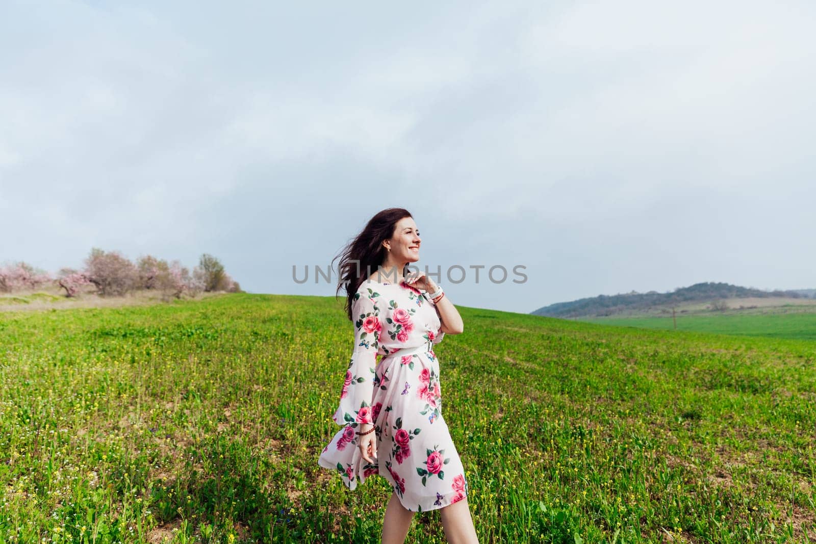 cheerful woman in green clearing on the street in a park in nature