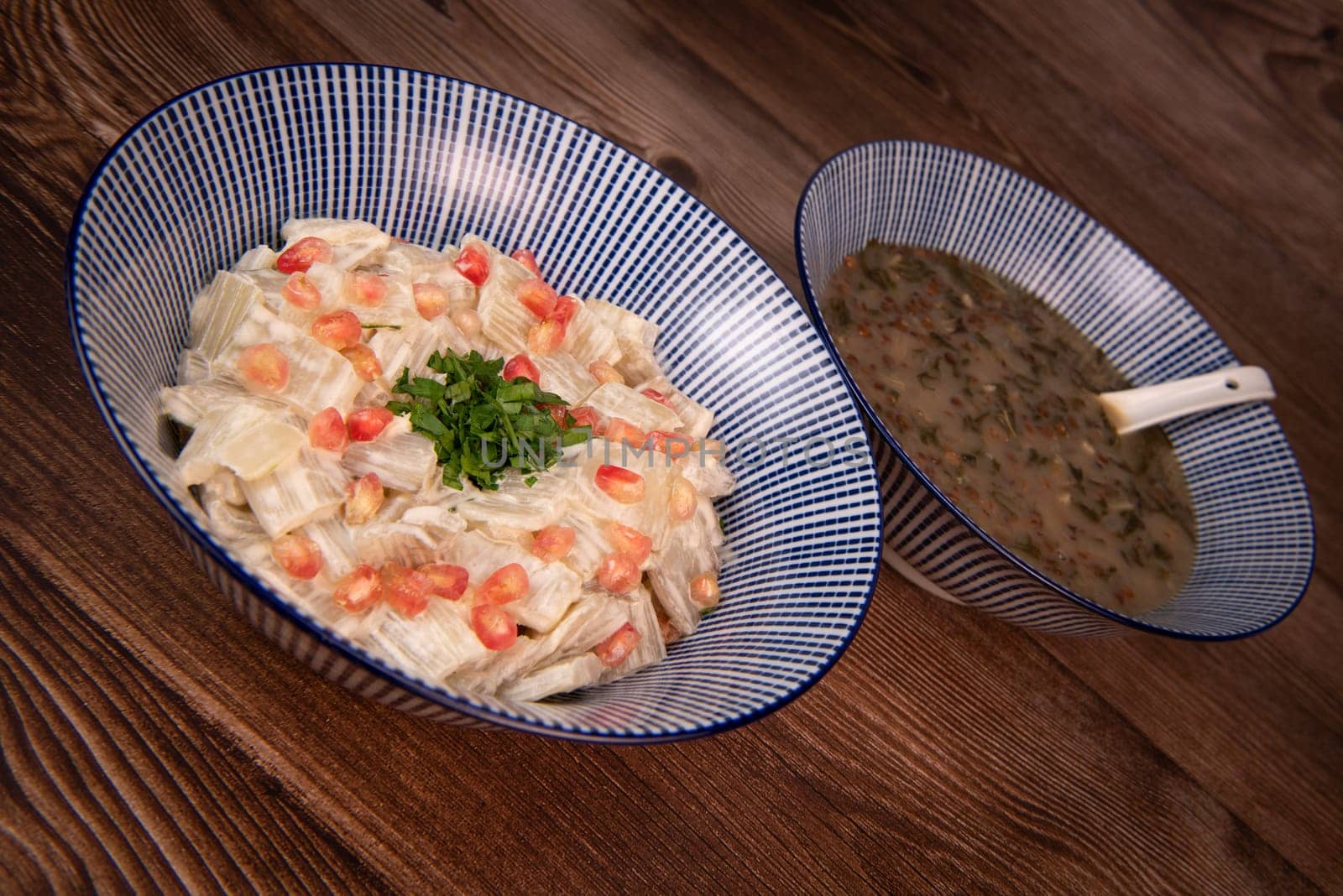 LEBANESE RECIPE FOR CHARD SOUP, LENTILS WITH LEMON, ADAS BI HAMOUD AND CHARD CHOPS, SESAME CREAM, TAHINI, POMEGRANATE SEEDS. High quality photo