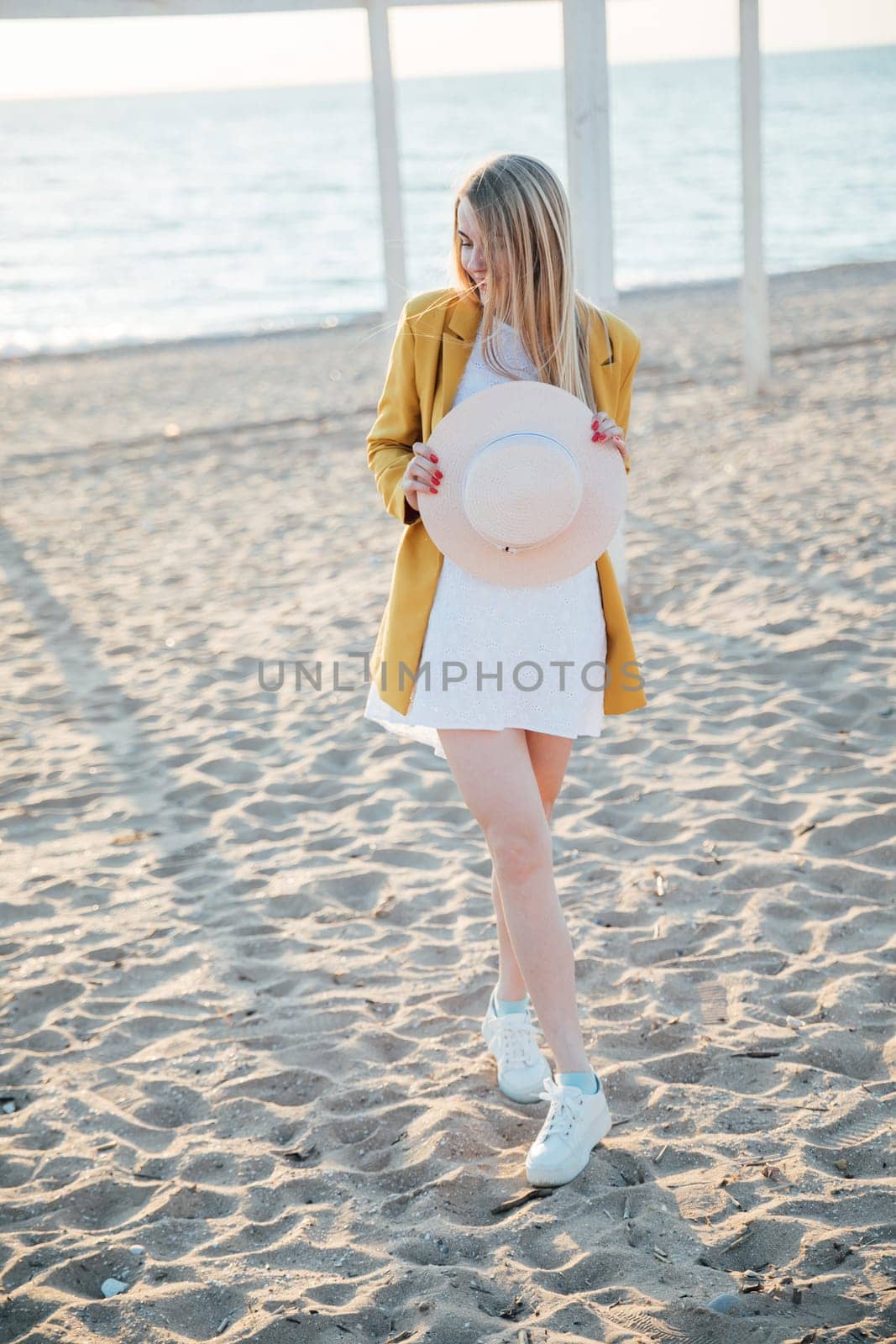 woman walks by the sea along the shore walk relaxing on the beach