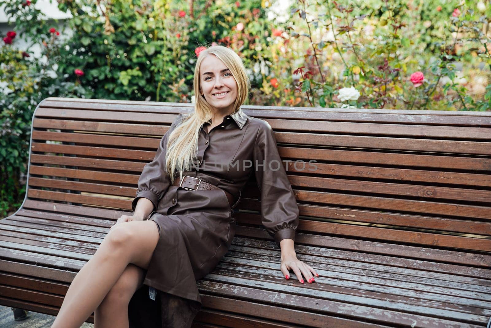 a rest blonde woman sitting on a bench walk