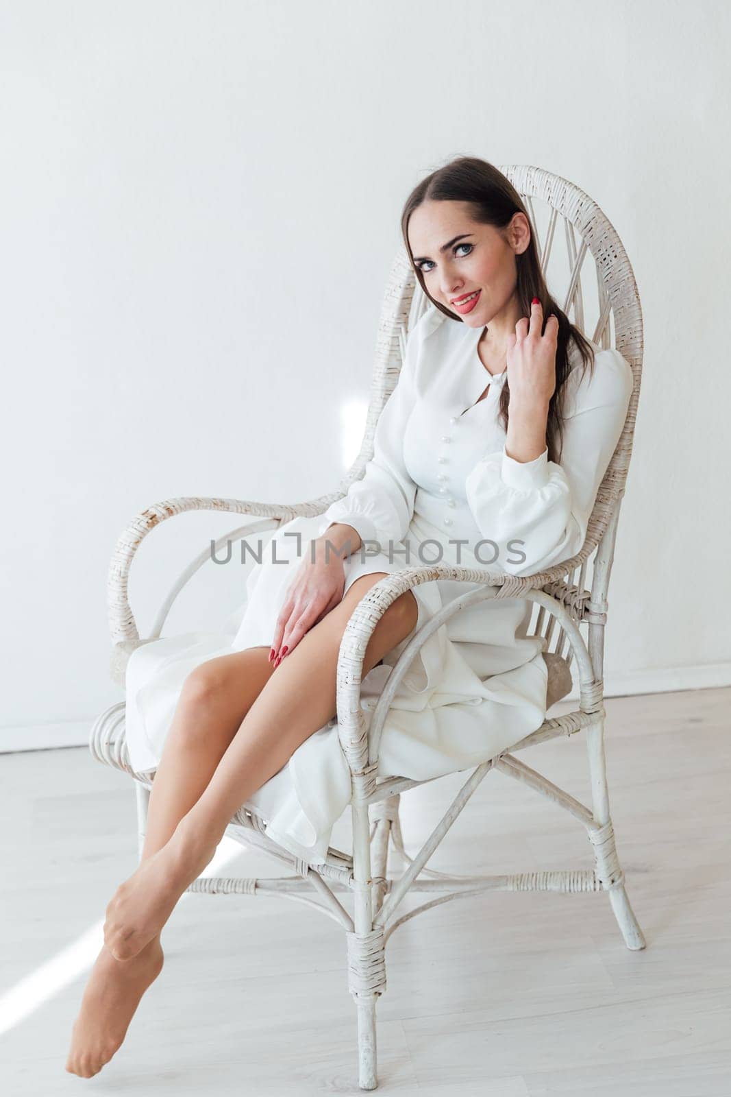 beautiful woman sitting in a chair in bright fashion room