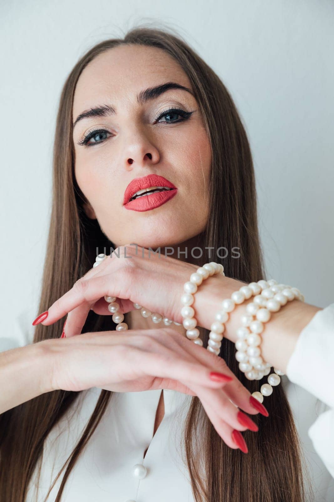 portrait of beautiful woman with beads jewelry on her arm