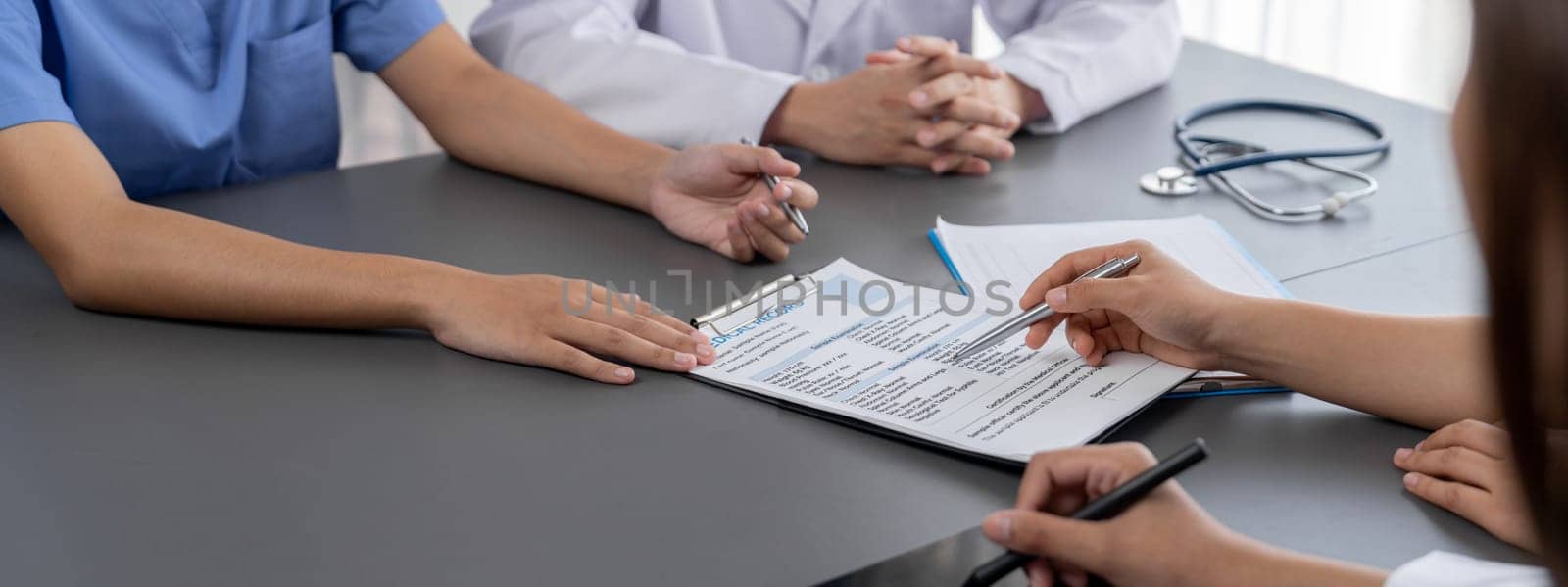 Doctor and nurse in medical meeting discussing strategic medical treatment plan together with report and laptop. Medical school workshop training concept in panoramic banner. Neoteric