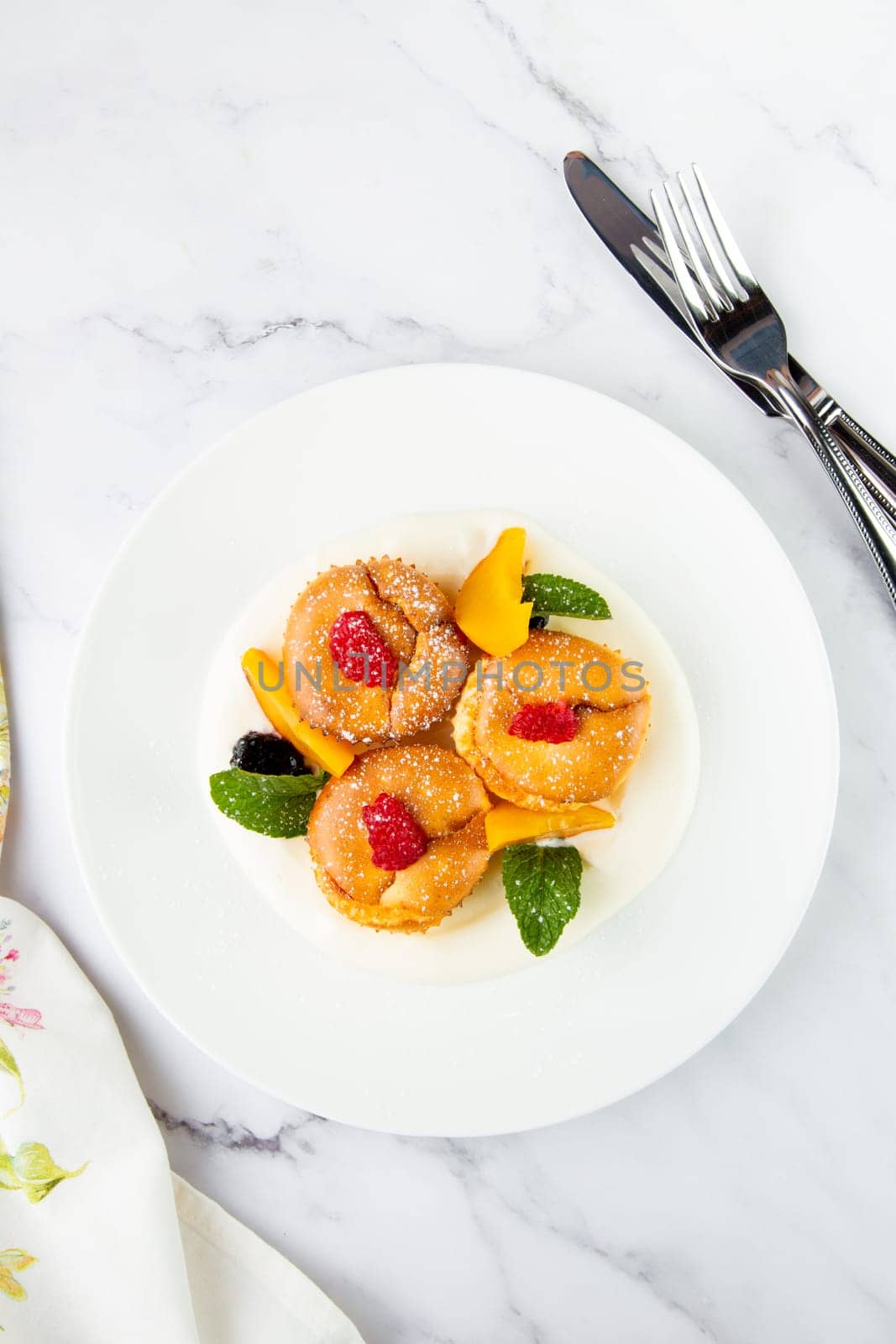 muffins with peach, raspberry, black berry and mint covered with powdered sugar