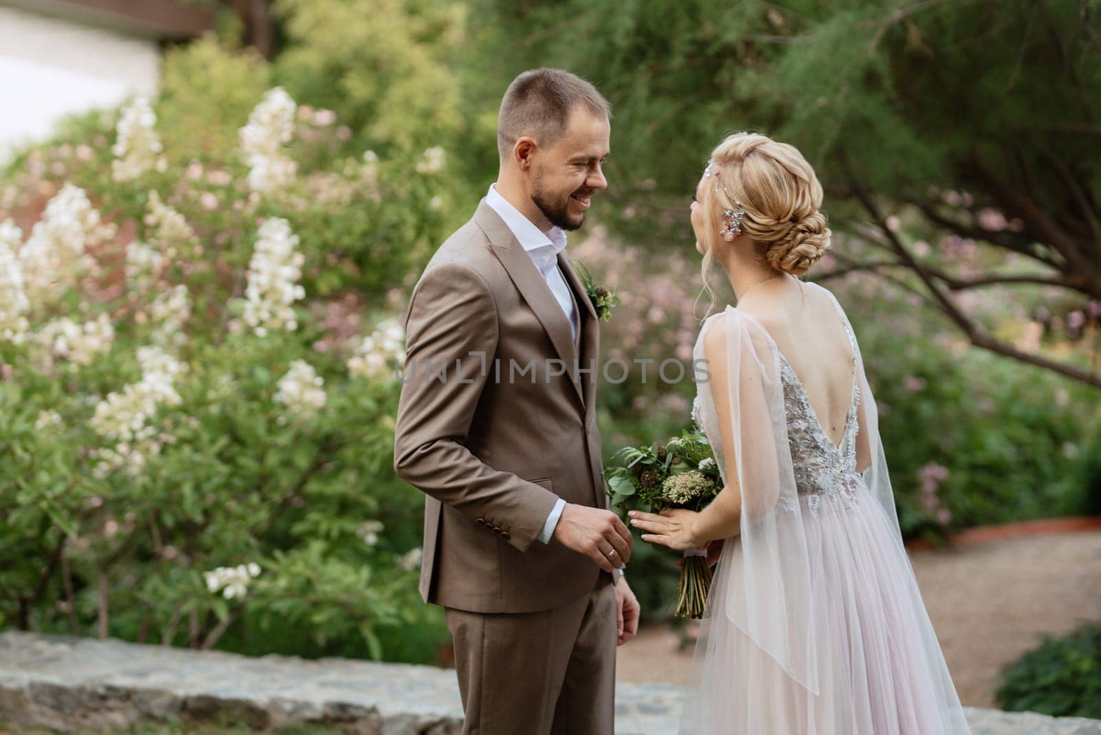 the first meeting of the bride and groom in wedding outfits in the park