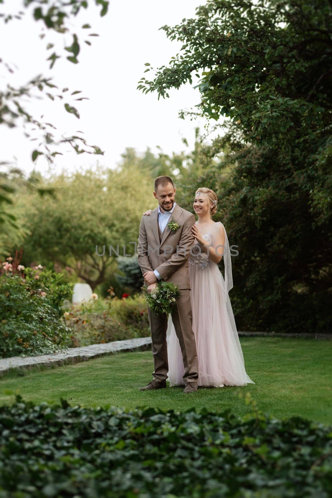 the first meeting of the bride and groom in wedding outfits in the park