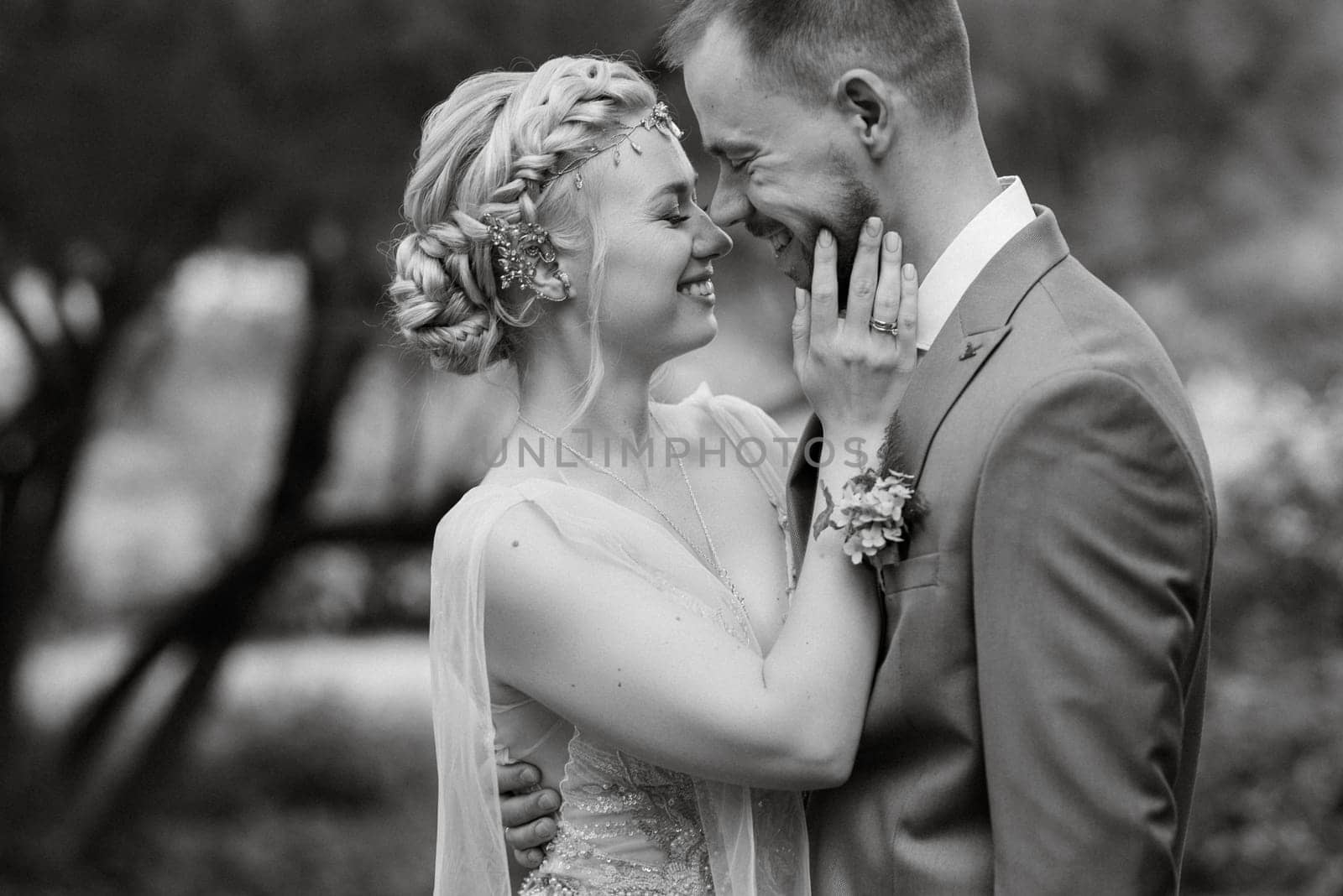 the first meeting of the bride and groom in wedding outfits in the park