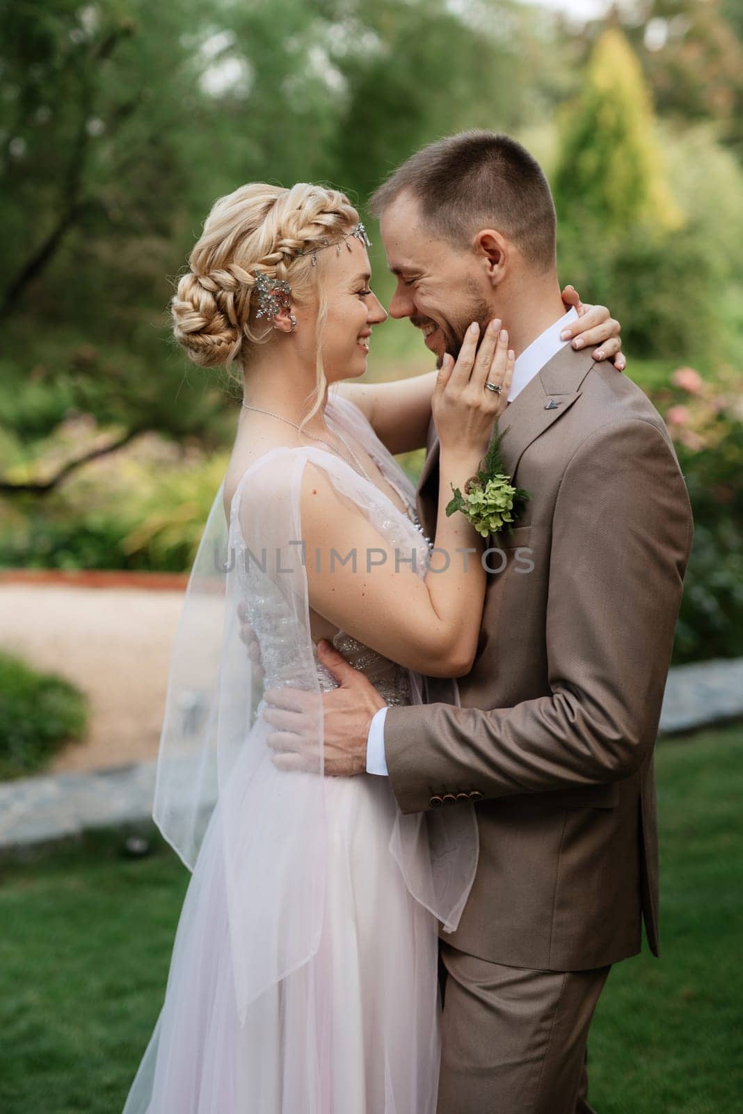 the first meeting of the bride and groom in wedding outfits in the park