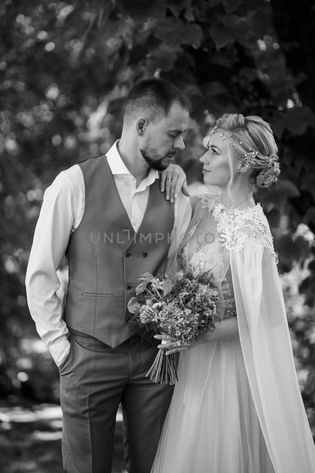 the first meeting of the bride and groom in wedding outfits in the park