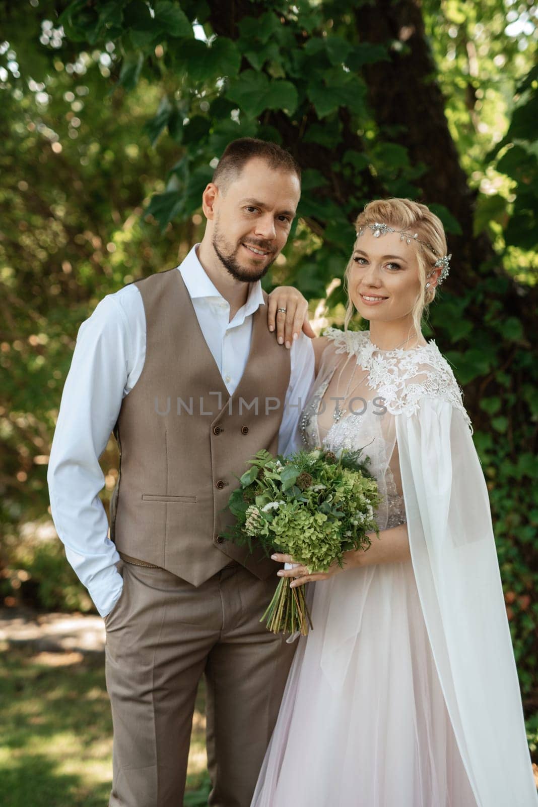 the first meeting of the bride and groom in wedding outfits in the park