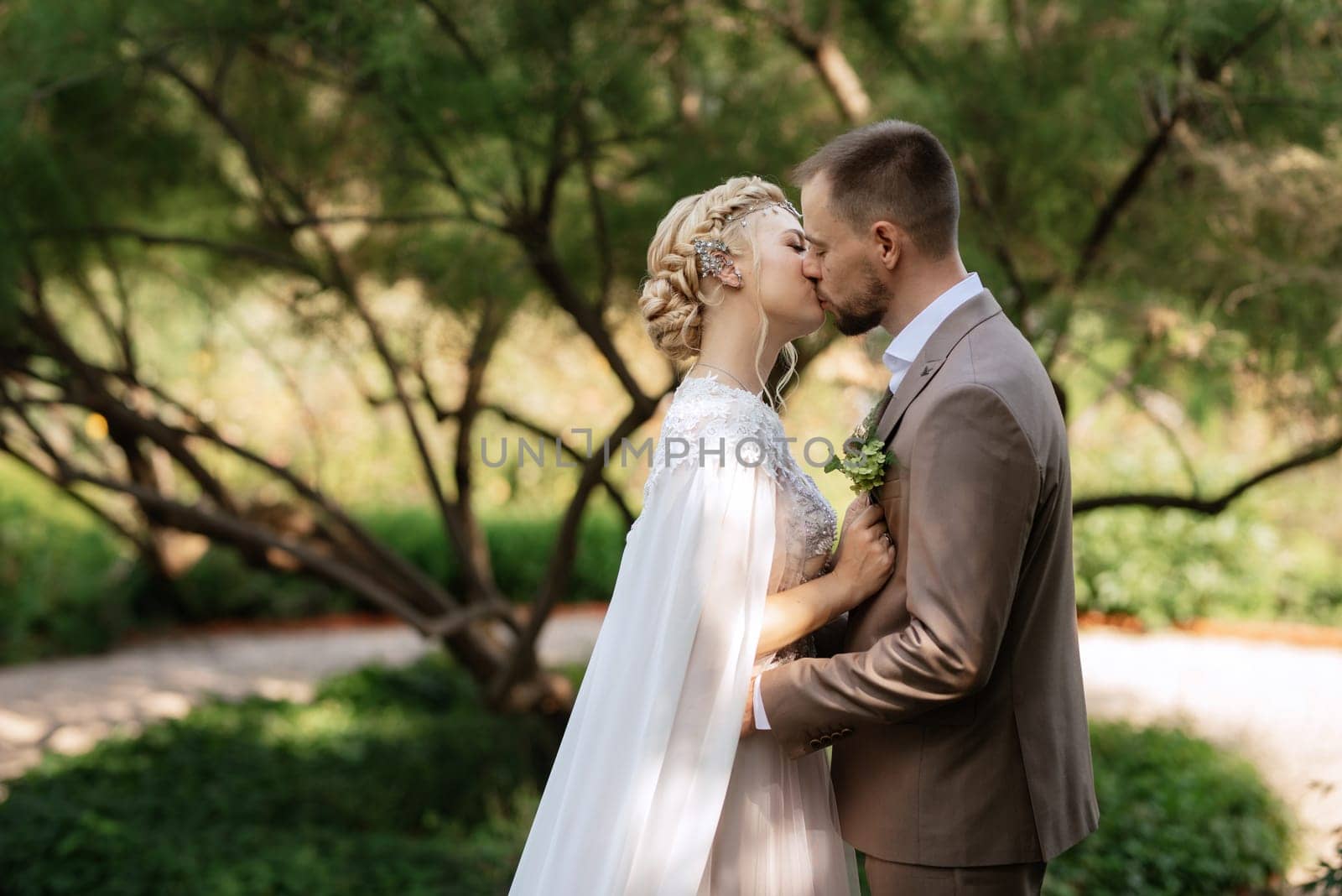 the first meeting of the bride and groom in wedding outfits in the park