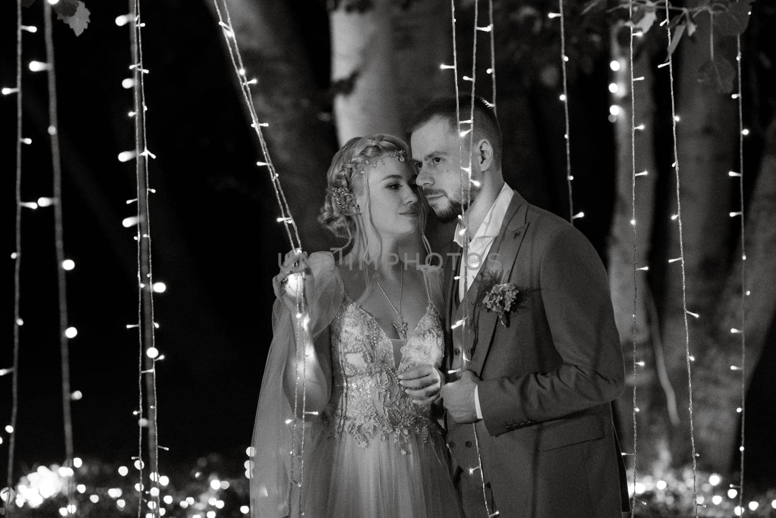 night wedding ceremony of the newlyweds in a country cottage on a green hill