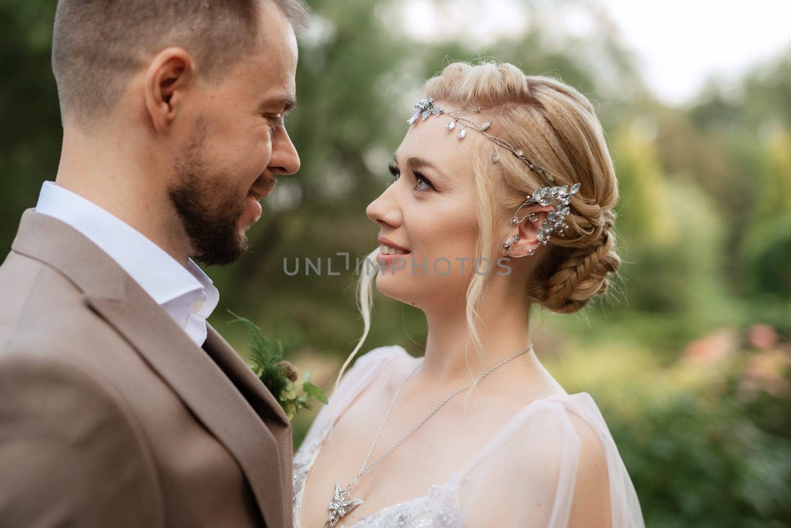 the first meeting of the bride and groom in wedding outfits in the park