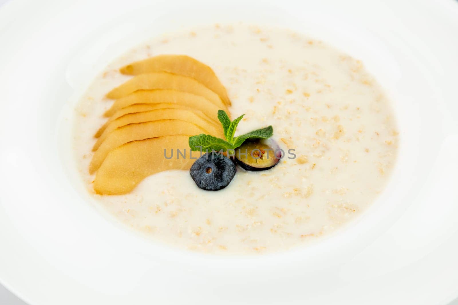 healthy breakfast with fruits in a white plate side view by tewolf