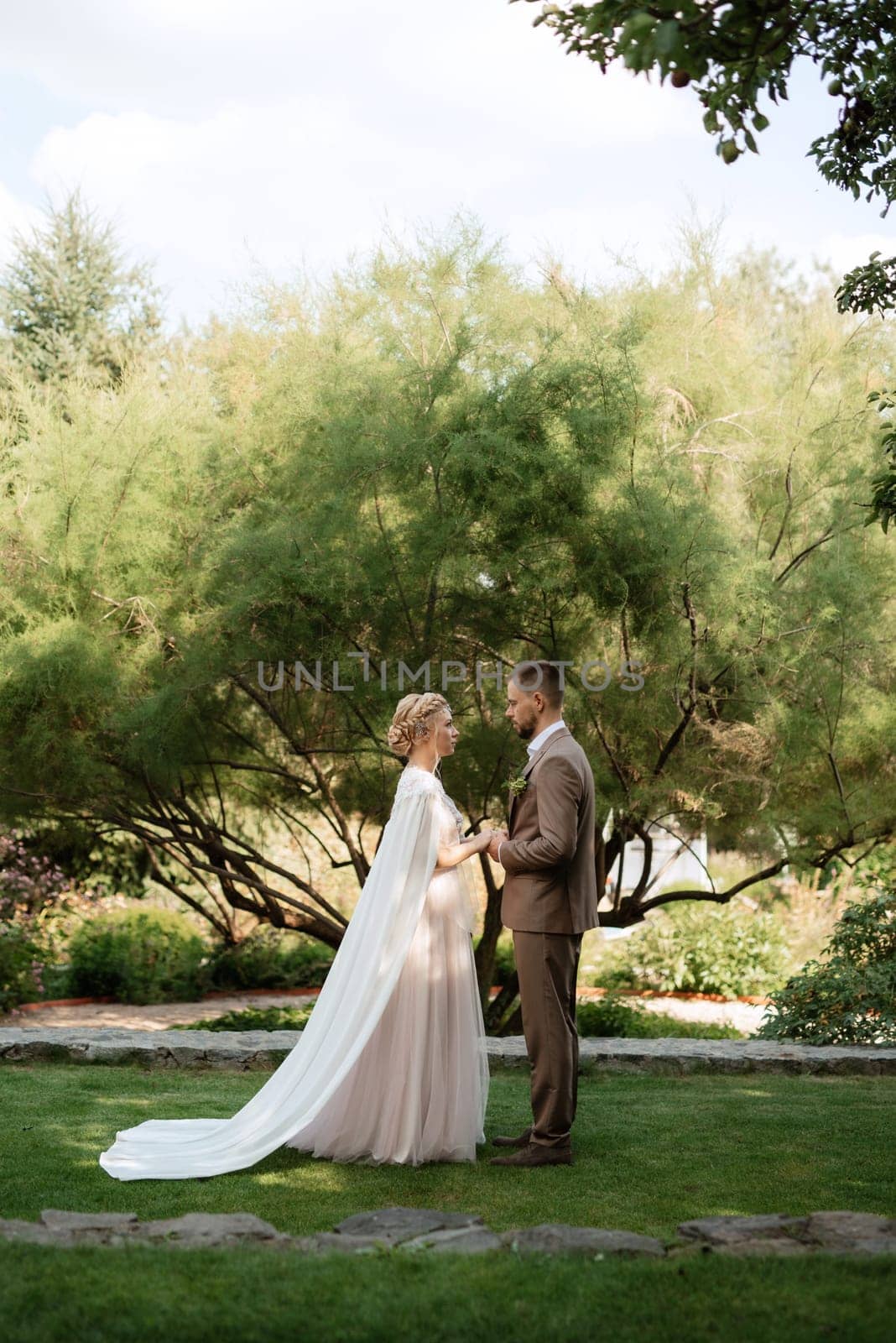 the first meeting of the bride and groom in wedding outfits in the park