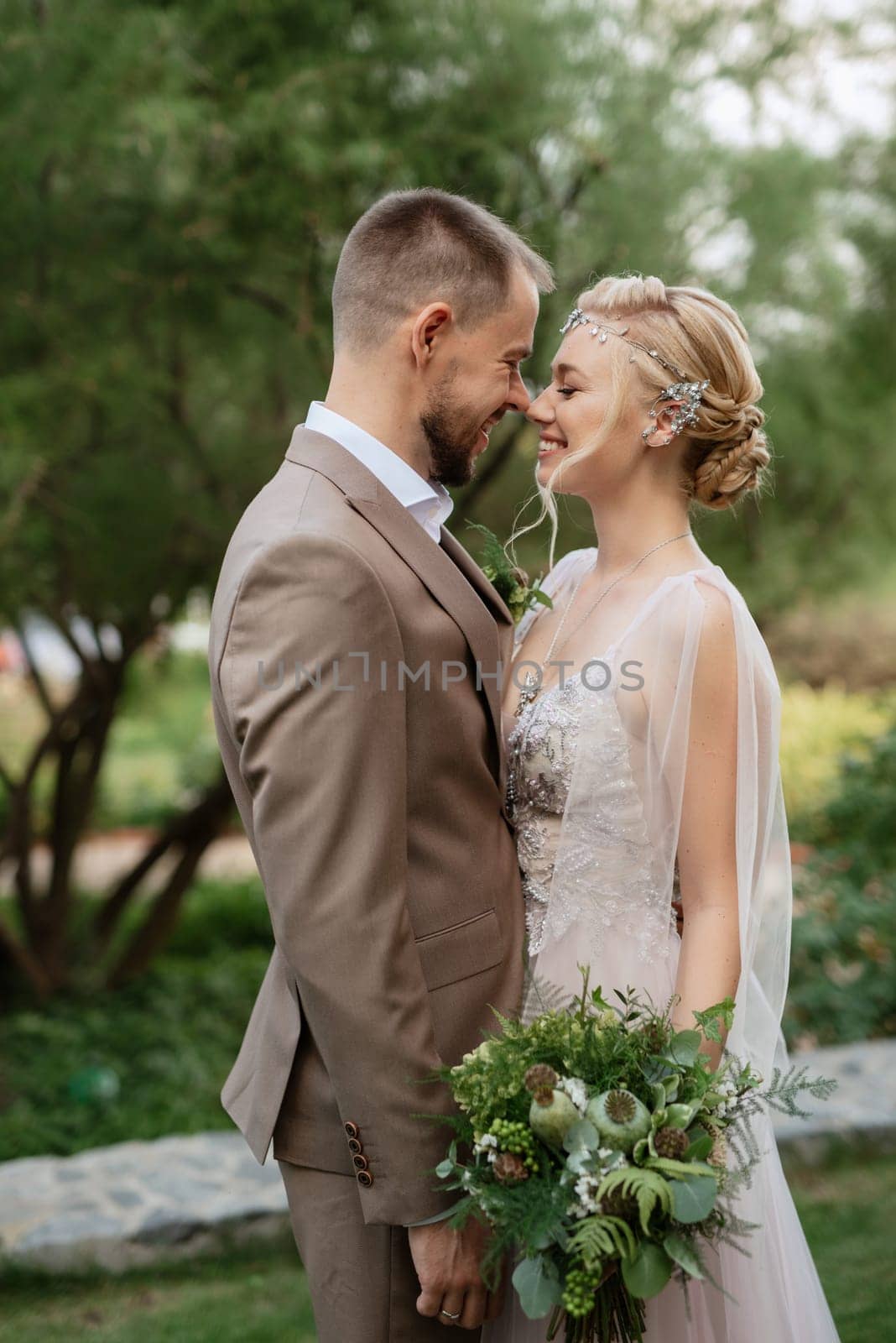 the first meeting of the bride and groom in wedding outfits in the park