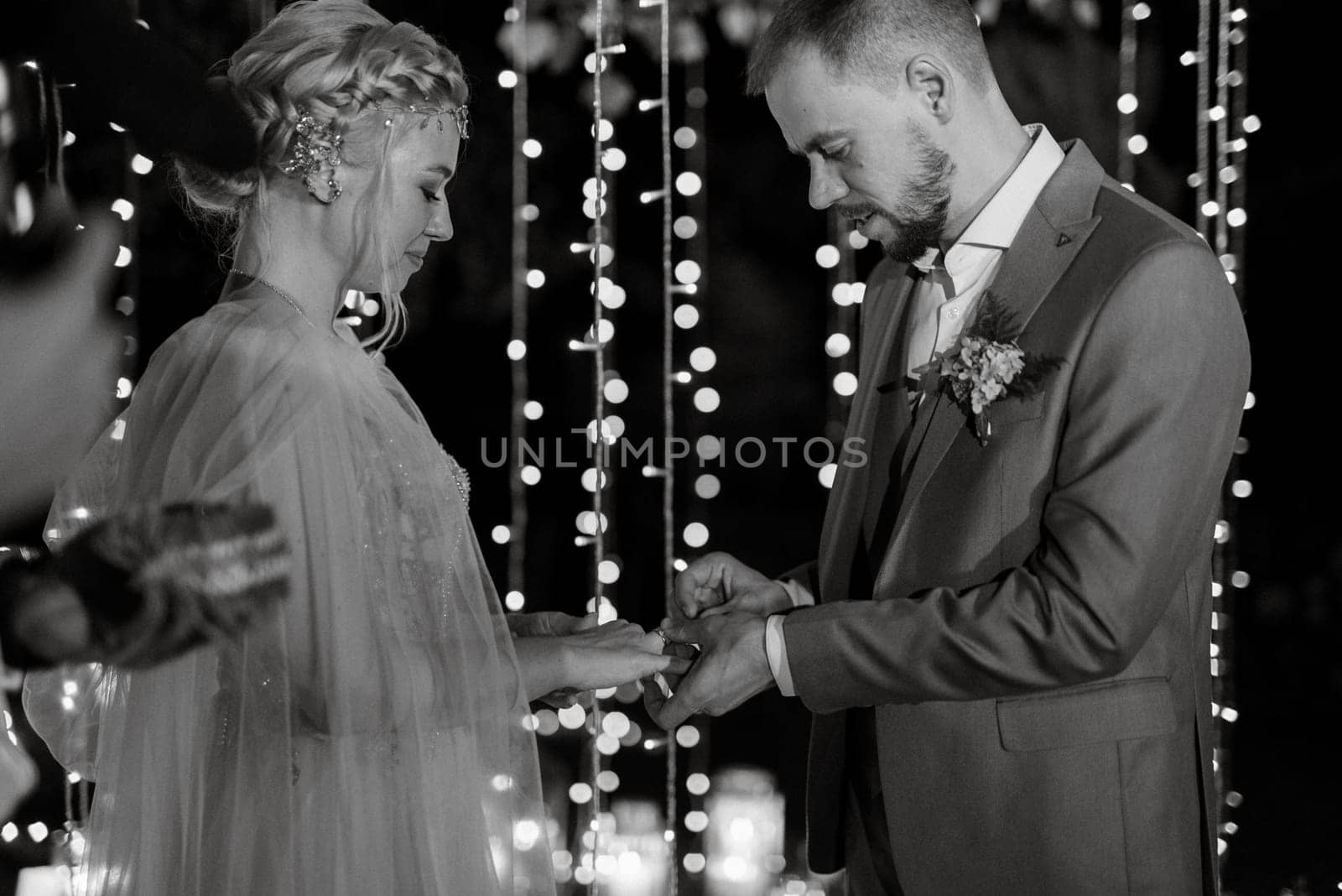 night wedding ceremony of the newlyweds in a country cottage on a green hill