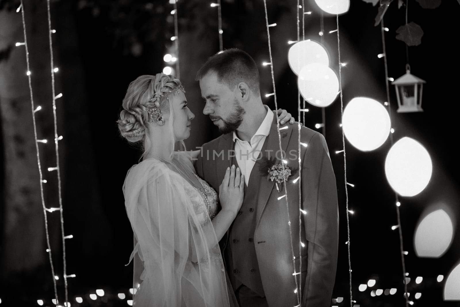 night wedding ceremony of the newlyweds in a country cottage on a green hill