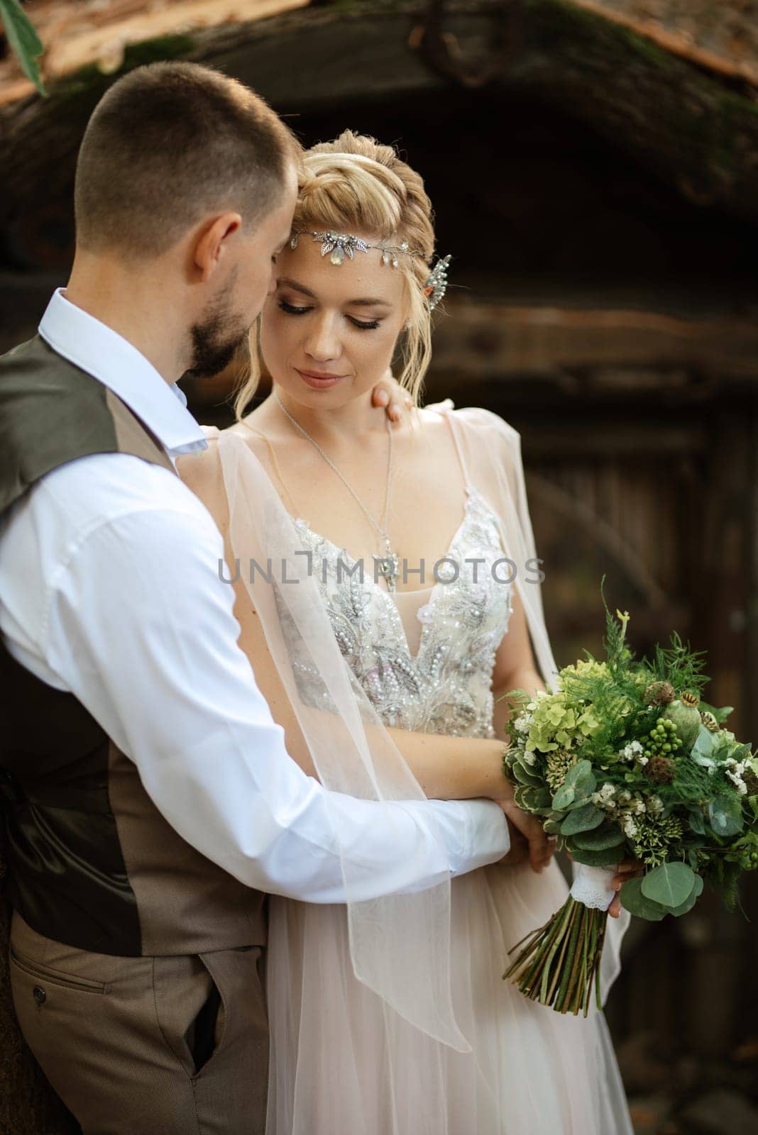 wedding walk of the bride and groom in a coniferous park in summer in elven accessories