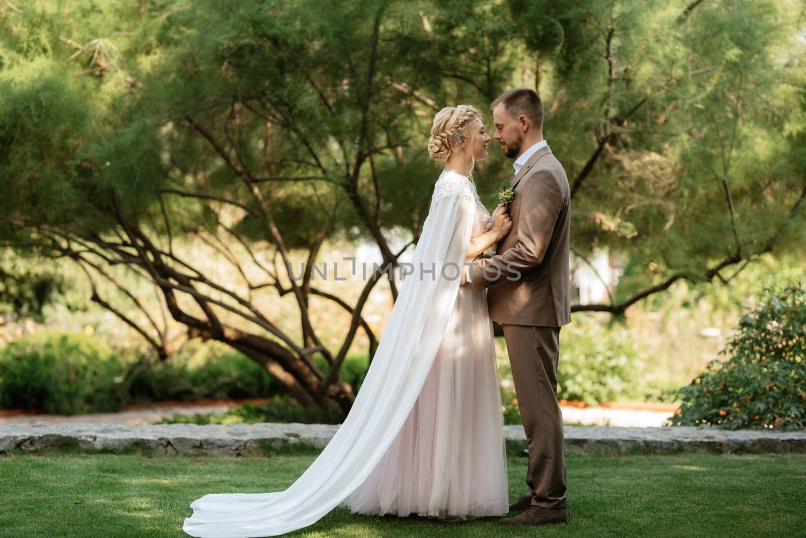 the first meeting of the bride and groom in wedding outfits in the park