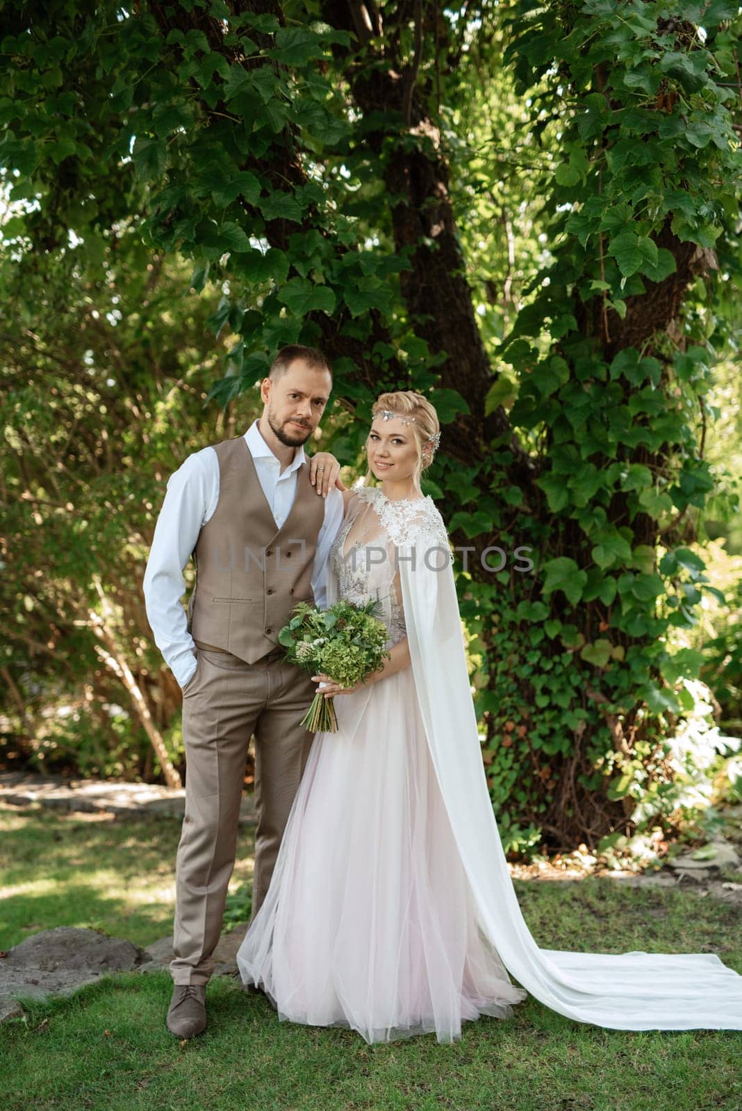 the first meeting of the bride and groom in wedding outfits in the park