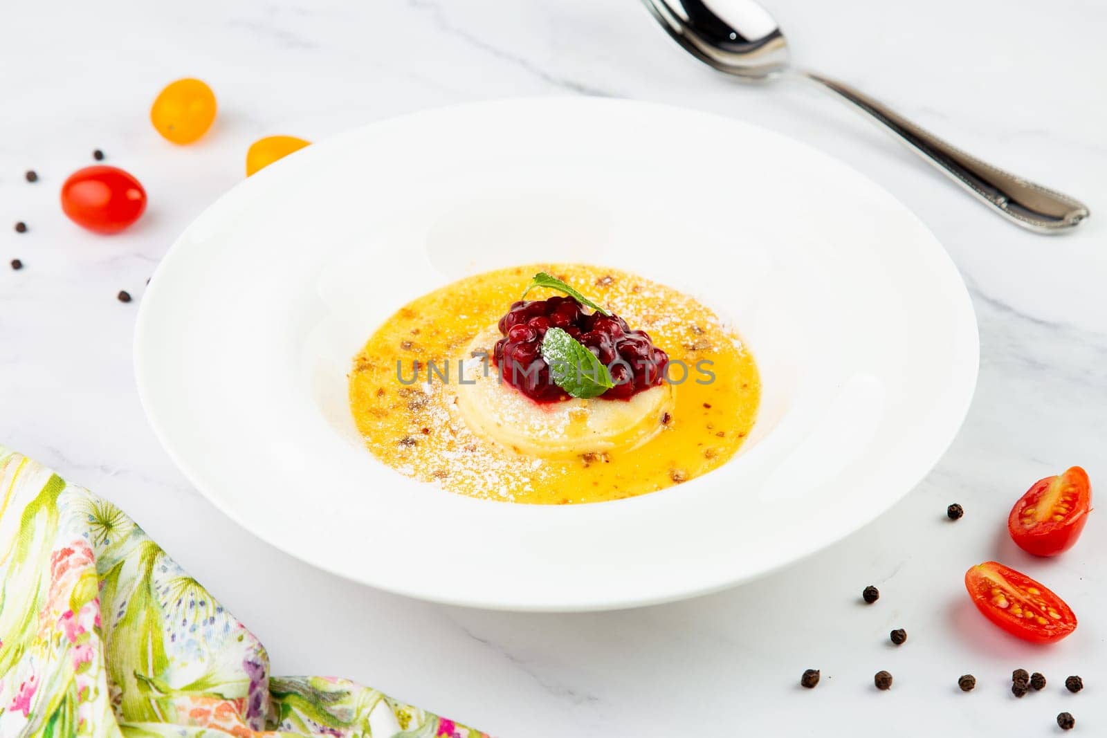 Ginger pumpkin soup with dumplings and berries. White background side view by tewolf