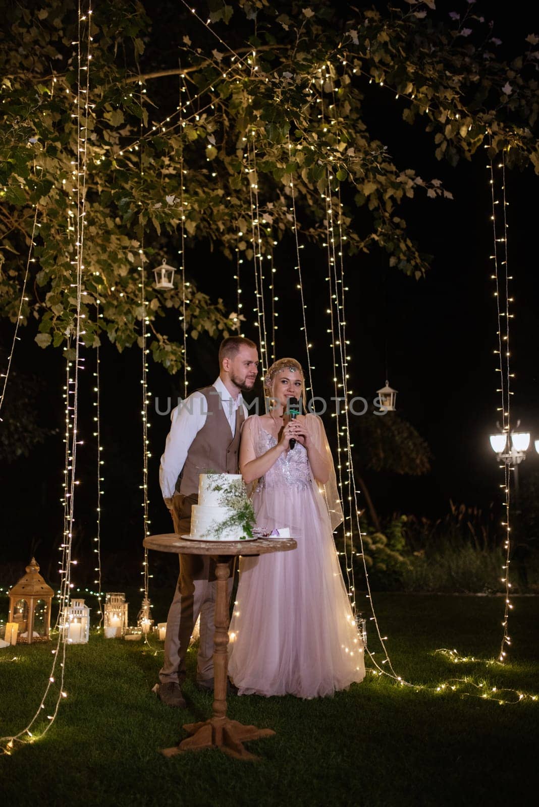 newlyweds happily cut and taste the wedding cake by Andreua