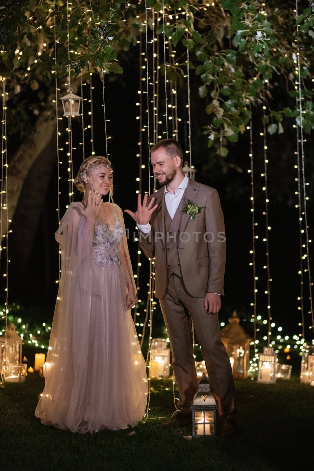 night wedding ceremony of the newlyweds in a country cottage on a green hill