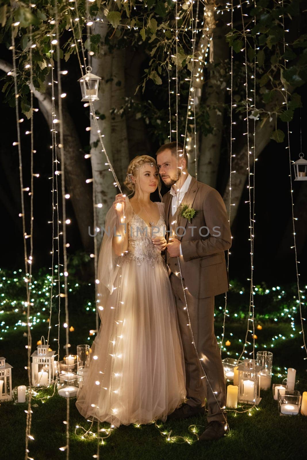 night wedding ceremony of the newlyweds in a country cottage on a green hill