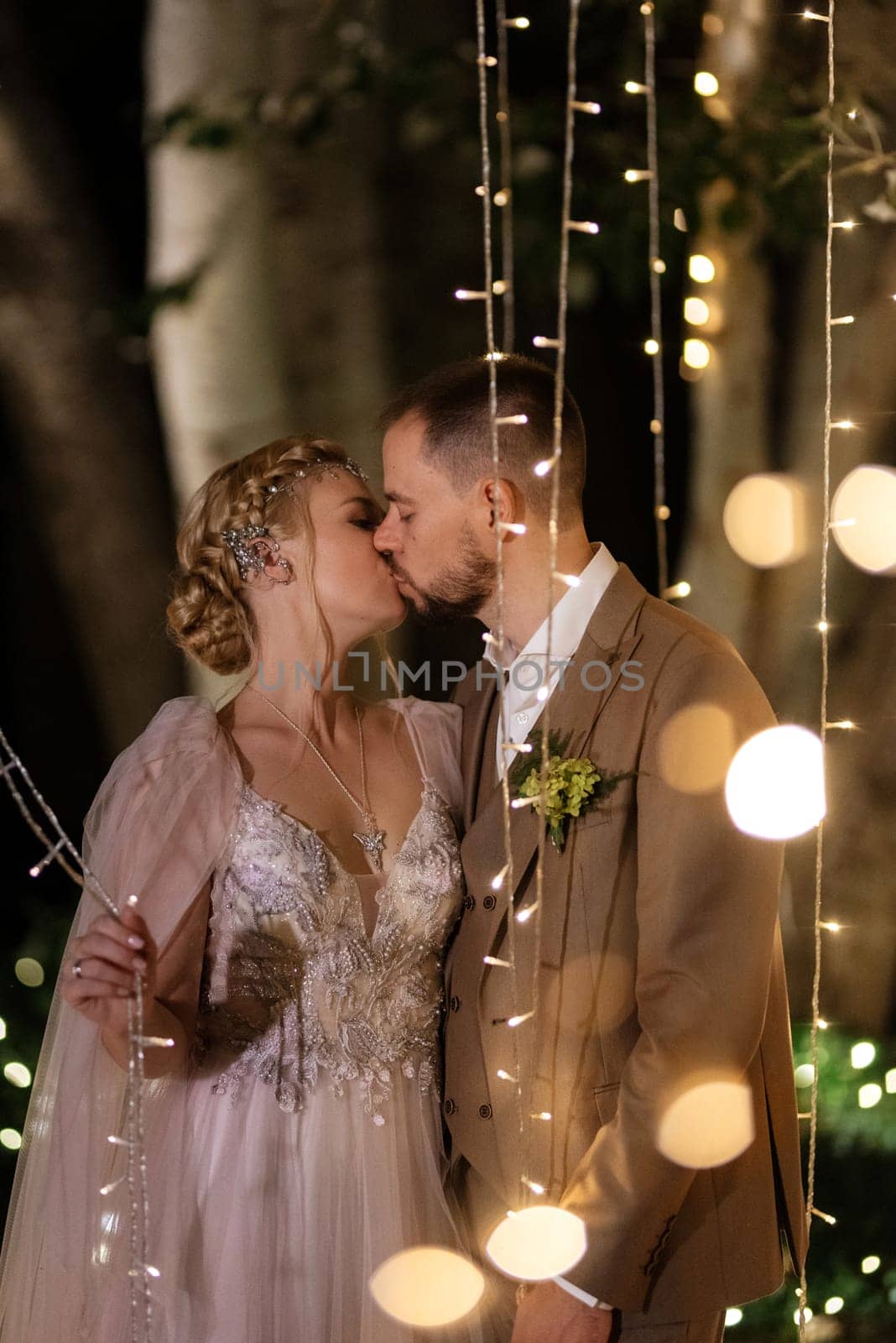 night wedding ceremony of the newlyweds in a country cottage on a green hill